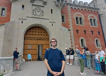 a student on a study abroad trip stands in front of a church